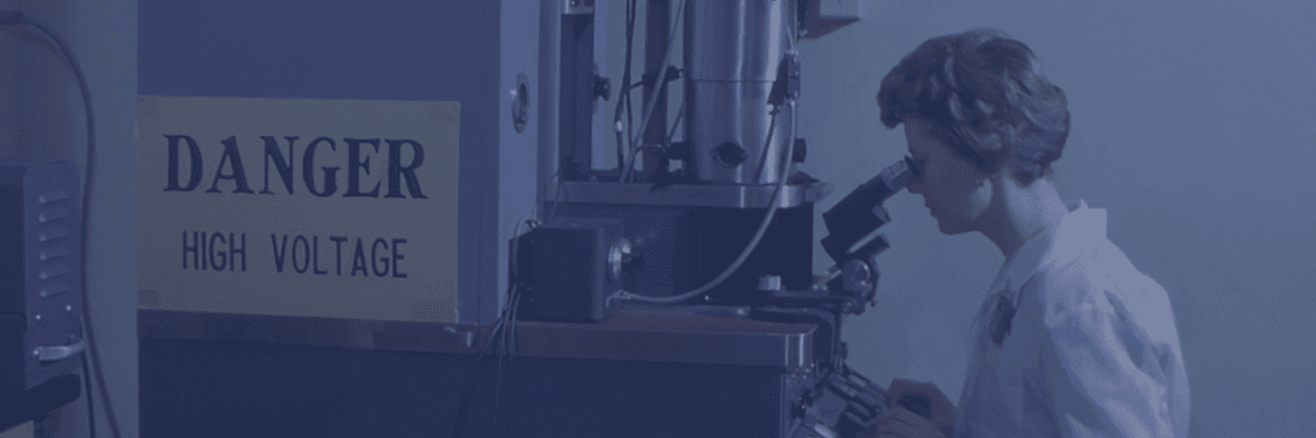 Woman looking through microscope